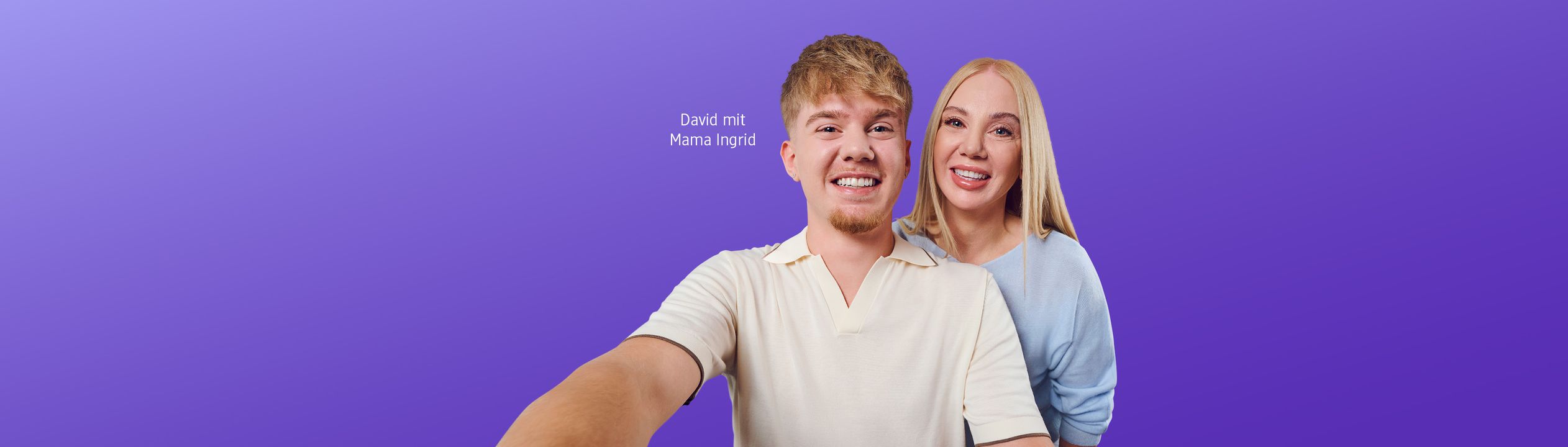 Ein junger Mann in cremefarbenem Hemd und eine blonde Frau in hellblauem Pullover lächeln fröhlich zusammen vor einem violetten Hintergrund.
