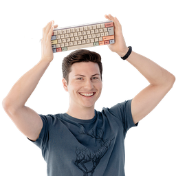 Junger Mann im T-Shirt hält eine bunte Entwickler-Tastatur über seinen Kopf